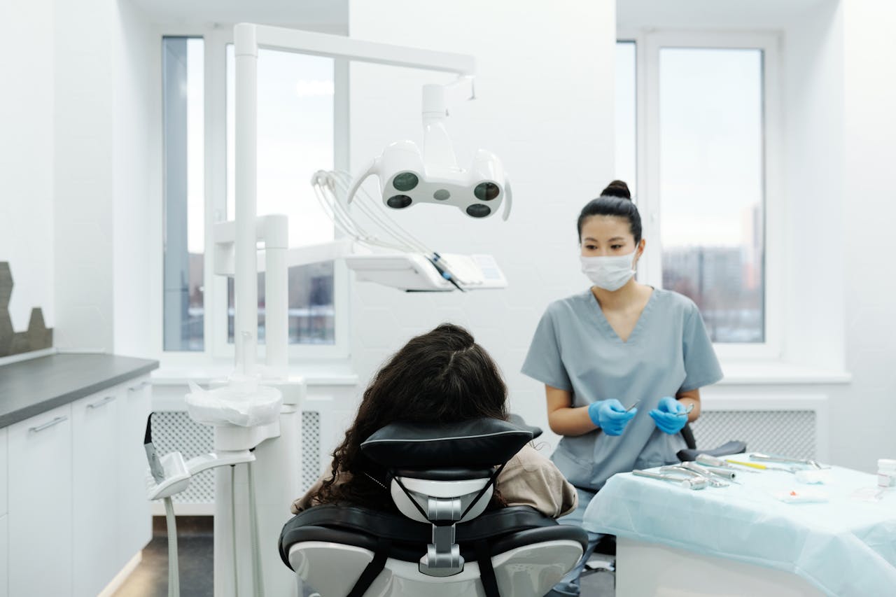 Dentist with a patient in a modern dental clinic performing an examination.