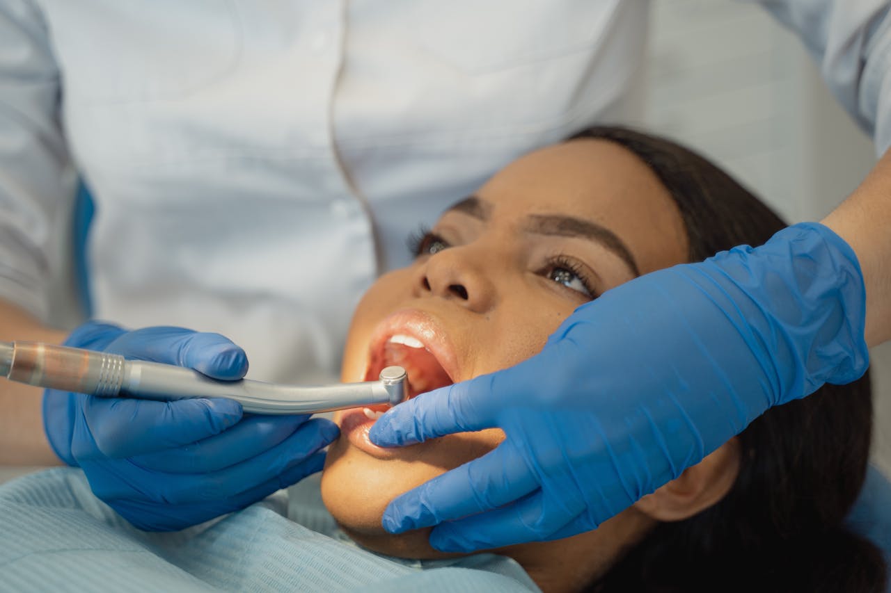 services-01 Close-up of a dentist performing a dental treatment on a patient.